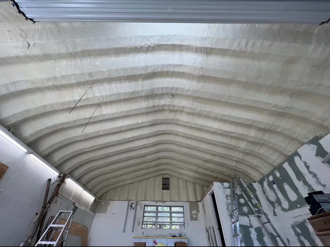 Spray polyurethane foam applied to the underside of a metal roof deck in Euclid
